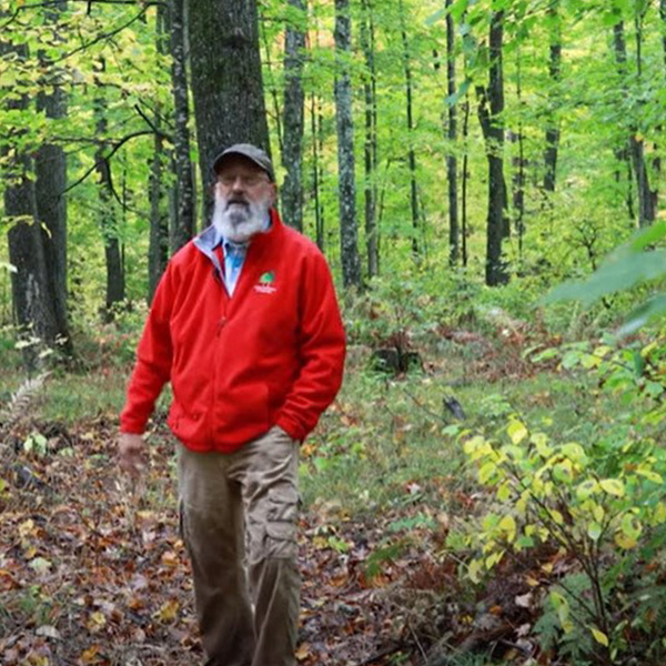 Bill Cook standing in forest